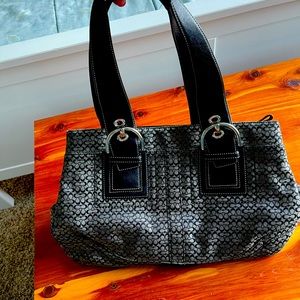 Black and gray Coach shoulder bag. Middle inside zip up pocket.